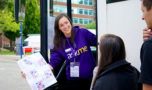 Female student wearing Askme hoodie welcoming prospective students on open day
