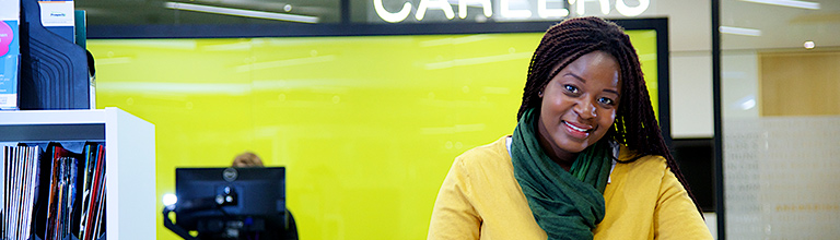 Female student smiling at the camera in the careers centre