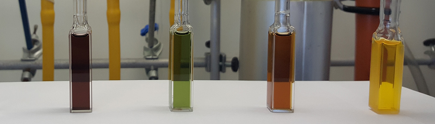 Bottles of coloured chemicals on a table