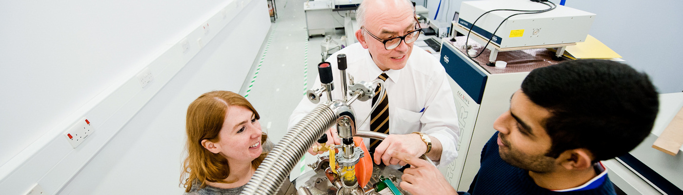 Professor talking to two researchers