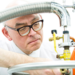 A researcher in glasses manoeuvring some EPR equipment