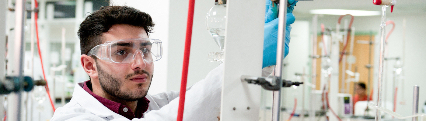 Student setting up equipment in a lab